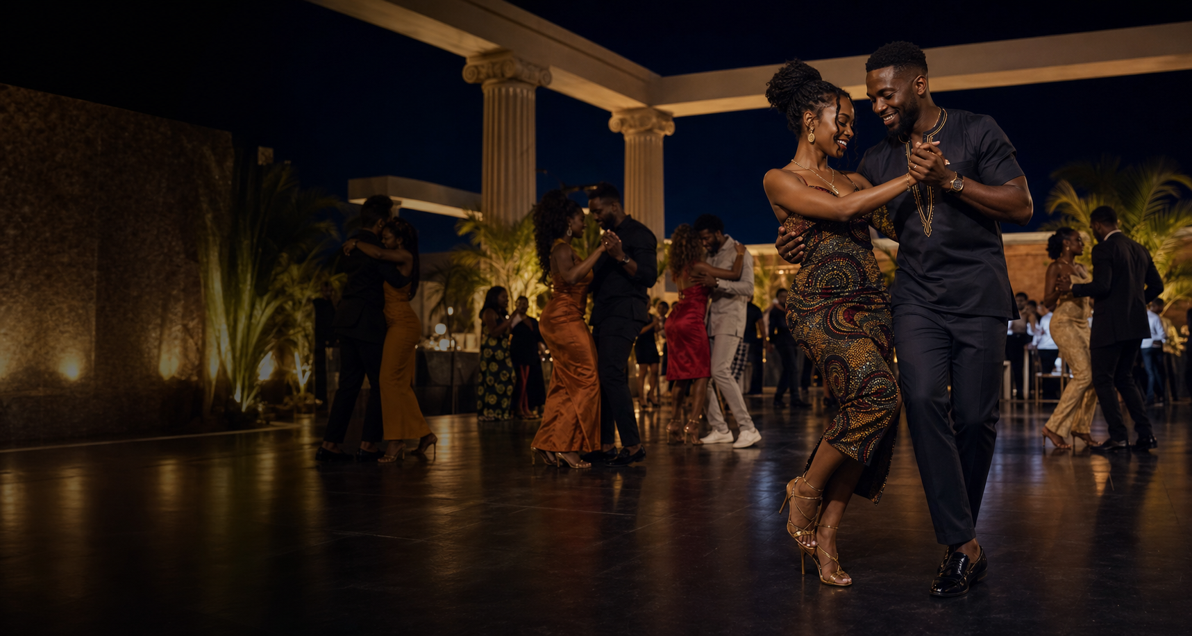 A couple dancing in the foreground at a KIZALSA night, with other couples dancing behind them
